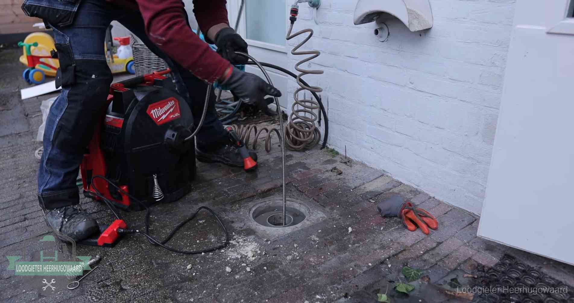 Erfgrens en gemeenteriool in Heerhugowaard Ontstoppingsputje in de bestrating naast de gevel van een woning in Heerhugowaard